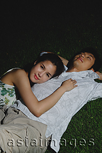 Asia Images Group - Young couple laying in grass, star gazing
