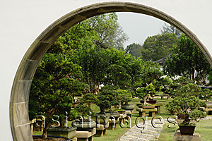 Asia Images Group - Bonsai trees seen through an arched doorway at the Chinese Garden, Singapore