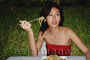 Asia Images Group - Woman in restaurant eating plate full of pasta