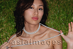 Asia Images Group - Woman wearing necklace, looking at camera