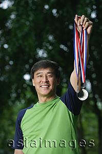 Asia Images Group - Man holding medals, winner, smiling