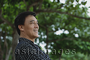 Asia Images Group - Man sitting in park, smiling
