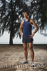Asia Images Group - Man standing in park along beach after running