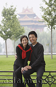 Asia Images Group - A couple smile at the camera as they in front of The Forbidden City, Beijing