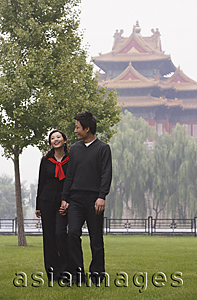 Asia Images Group - A couple walk in front of The Forbidden City, Beijing