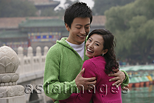 Asia Images Group - A couple smile as they hug