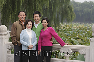 Asia Images Group - A family look at the camera as they pose for photos together while on vacation