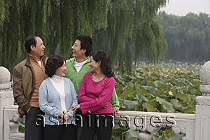 Asia Images Group - A family stand together on a bridge