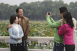 Asia Images Group - A family pose for photos together while on vacation