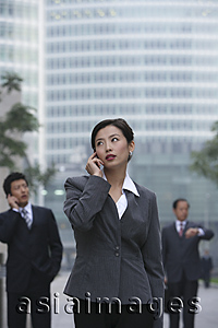 Asia Images Group - A businesswoman uses her cellphone