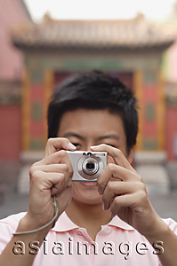 Asia Images Group - A man looks at the camera and takes a photo