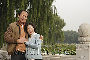 Asia Images Group - A couple look at the camera with their arms around each other