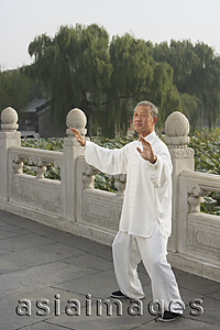 Asia Images Group - An old man practices Chinese martial arts