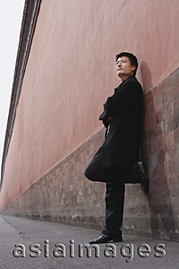 Asia Images Group - A man leans against a wall