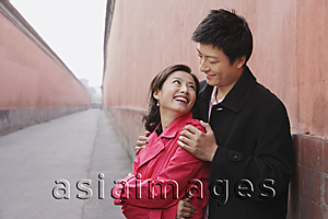 Asia Images Group - A couple cuddle and smile at each other