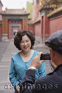Asia Images Group - A woman smiles as she has her photo taken while on vacation