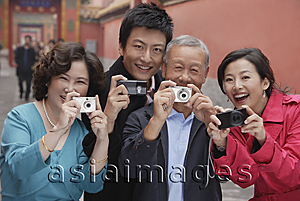 Asia Images Group - A family all hold up their cameras to take photos