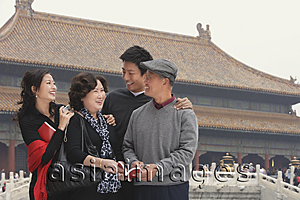 Asia Images Group - A family pose for photos together in front of The Forbidden City, Beijing