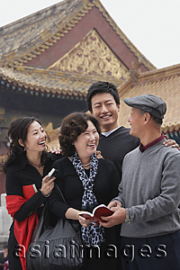 Asia Images Group - A family laugh together in front of The Forbidden City, Beijing