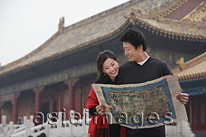 Asia Images Group - A tourist couple look at a map together in front of The Forbidden City, Beijing