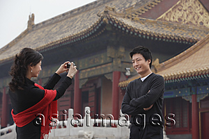 Asia Images Group - A couple take photos of each other in front of The Forbidden City, Beijing