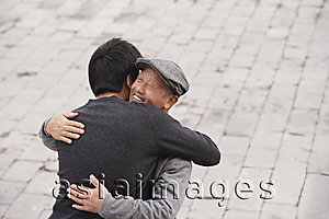 Asia Images Group - A grandfather and grandson hug each other