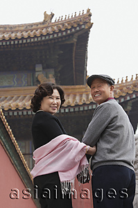 Asia Images Group - A man and a woman look back at the camera in The Forbidden City, Beijing