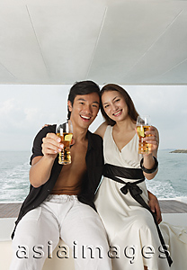 Asia Images Group - Couple on yacht, smiling at camera