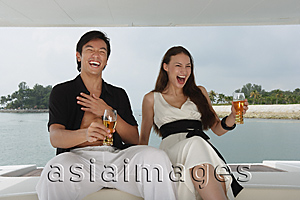 Asia Images Group - Couple on yacht, laughing
