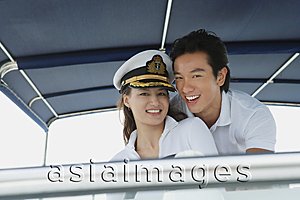 Asia Images Group - Young couple on yacht, smiling at camera