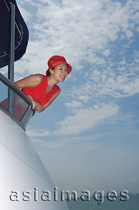 Asia Images Group - Young woman on yacht, looking at camera