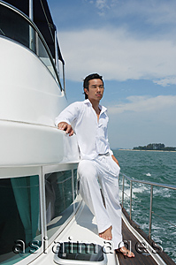 Asia Images Group - Young man on yacht, looking into distance