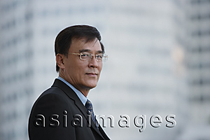 Asia Images Group - Businessman in the city, looking at camera
