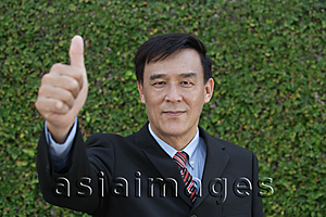 Asia Images Group - Businessman giving his thumb up