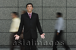 Asia Images Group - Businessman standing in crowd