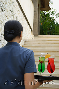 Asia Images Group - Balinese waitress carrying cocktails