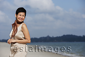 Asia Images Group - Woman at the beach, looking into distance