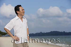 Asia Images Group - Man at the beach, looking into distance