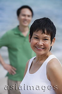 Asia Images Group - Mature couple at the beach, smiling at camera