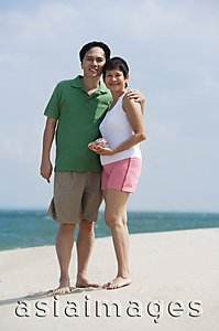 Asia Images Group - Mature couple at the beach smiling at camera