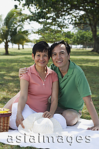Asia Images Group - Mature couple having a picnic in the park, smiling at camera