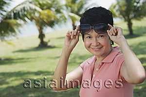 Asia Images Group - Woman in park smiling at camera