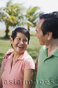 Asia Images Group - Mature couple in the park smiling at each other