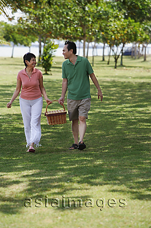 Asia Images Group - Mature couple in the park going for a picnic