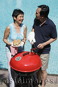 Asia Images Group - Mature couple having a barbeque