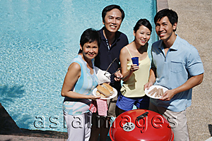 Asia Images Group - Family enjoying barbeque by the pool