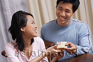 Asia Images Group - Man giving woman a small present