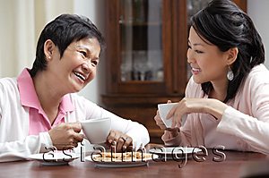 Asia Images Group - Mother and daughter enjoying tea together