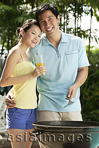 Asia Images Group - Young couple enjoying a barbeque