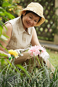 Asia Images Group - Woman doing gardening